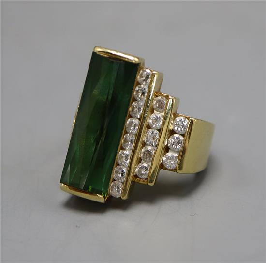 A continental 18k, green tourmaline and diamond set dress ring, bearing the stamp Hubert, size M.